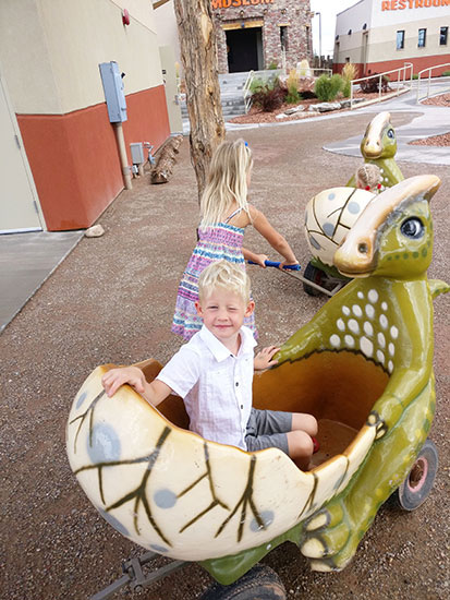 Dinosaur Stroller with children in it